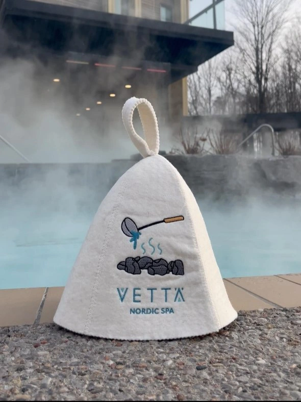 Vettä Nordic Spa sauna hat beside a steaming outdoor pool